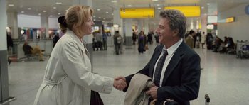 Movie still from “Last Chance Harvey” (2008), directed by Joel Hopkins – A man and a woman shaking hands in an airport; Medium shot, Over the shoulder angle