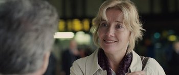 Movie still from “Last Chance Harvey” (2008), directed by Joel Hopkins – A person smiling at the camera; Close Up shot, Over the shoulder angle