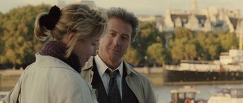Movie still from “Last Chance Harvey” (2008), directed by Joel Hopkins – A man and a woman standing next to each other near a river; Close Up shot, Over the shoulder angle