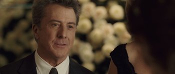 Movie still from “Last Chance Harvey” (2008), directed by Joel Hopkins – A person wearing a suit and tie; Close Up shot, Over the shoulder angle