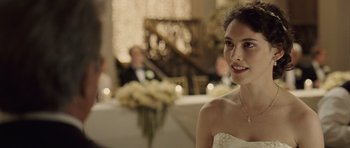 Movie still from “Last Chance Harvey” (2008), directed by Joel Hopkins – A woman in a white dress smiling for the camera; Close Up shot, Over the shoulder angle