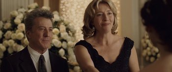 Movie still from “Last Chance Harvey” (2008), directed by Joel Hopkins – A woman in a black dress and a man in a black suit; Medium shot, Over the shoulder angle