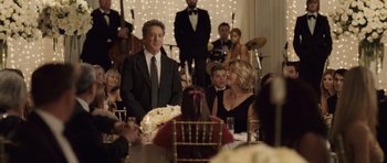 Movie still from “Last Chance Harvey” (2008), directed by Joel Hopkins – A group of people sitting around a table at an event; Medium shot, Over the shoulder angle