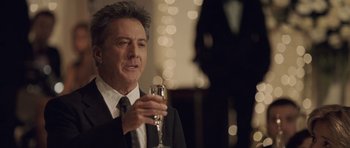 Movie still from “Last Chance Harvey” (2008), directed by Joel Hopkins – A man in a suit holding a glass of wine; Close Up shot, Over the shoulder angle