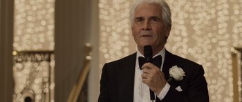 Movie still from “Last Chance Harvey” (2008), directed by Joel Hopkins – An older man in a tuxedo holding a microphone; Close Up shot, Over the shoulder angle