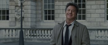 Movie still from “Last Chance Harvey” (2008), directed by Joel Hopkins – A man standing in front of a stone building; Close Up shot, Over the shoulder angle