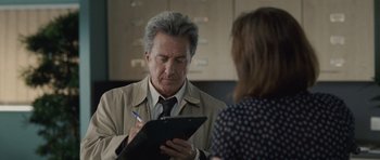 Movie still from “Last Chance Harvey” (2008), directed by Joel Hopkins – An older man writing on a clipboard while a woman looks on; Close Up shot, Over the shoulder angle