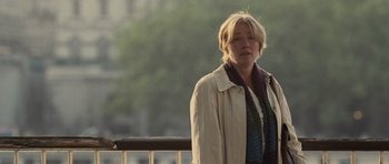 Movie still from “Last Chance Harvey” (2008), directed by Joel Hopkins – A woman standing next to a railing in a park; Medium shot, Over the shoulder angle
