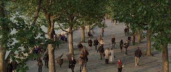 Movie still from “Last Chance Harvey” (2008), directed by Joel Hopkins – A group of people walking down a sidewalk near trees; Extreme Wide shot, High angle