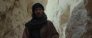 Movie still from “Last Days in the Desert” (2015), directed by Rodrigo García – A man wearing a scarf and a turban; Medium shot, Low angle