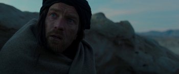 Movie still from “Last Days in the Desert” (2015), directed by Rodrigo García – A person wearing a blanket; Close Up shot, Low angle