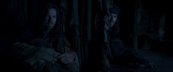 Movie still from “Last Days in the Desert” (2015), directed by Rodrigo García – Two men sitting next to each other in a dark room; Medium shot, Low angle