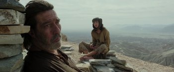 Movie still from “Last Days in the Desert” (2015), directed by Rodrigo García – A man and a woman sitting on top of a hill; Medium shot, Low angle