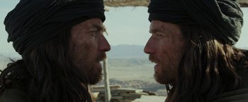 Movie still from “Last Days in the Desert” (2015), directed by Rodrigo García – Two men with long hair are facing each other; Close Up shot, Over the shoulder angle