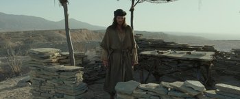 Movie still from “Last Days in the Desert” (2015), directed by Rodrigo García – A man dressed as jesus standing in a field of rocks; Wide shot, Low angle