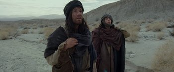 Movie still from “Last Days in the Desert” (2015), directed by Rodrigo García – A man and a woman dressed in biblical clothing; Medium shot, Low angle