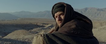 Movie still from “Last Days in the Desert” (2015), directed by Rodrigo García – A man with a beard wearing a head covering; Medium shot, Low angle