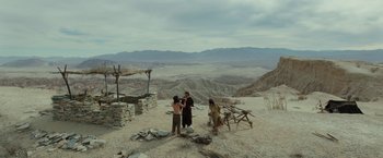 Movie still from “Last Days in the Desert” (2015), directed by Rodrigo García – A group of people standing on top of a sandy hill; Extreme Wide shot, High angle