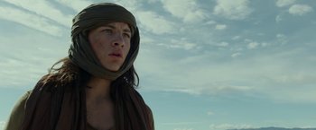 Movie still from “Last Days in the Desert” (2015), directed by Rodrigo García – A young man wearing a headscarf looking up at the sky; Close Up shot, Low angle