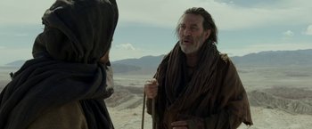 Movie still from “Last Days in the Desert” (2015), directed by Rodrigo García – A man with long hair and a beard talking to another man; Medium shot, Over the shoulder angle