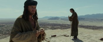 Movie still from “Last Days in the Desert” (2015), directed by Rodrigo García – Two men standing on top of a hill near a desert; Medium shot, Over the shoulder angle