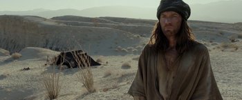 Movie still from “Last Days in the Desert” (2015), directed by Rodrigo García – A man standing in the middle of the desert; Medium shot, Over the shoulder angle