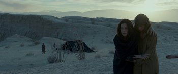 Movie still from “Last Days in the Desert” (2015), directed by Rodrigo García – A woman standing in the sand near a tent; Medium shot, Low angle