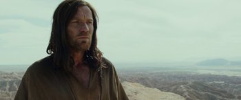 Movie still from “Last Days in the Desert” (2015), directed by Rodrigo García – A person with long hair; Close Up shot, Over the shoulder angle