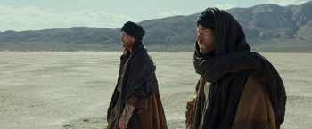 Movie still from “Last Days in the Desert” (2015), directed by Rodrigo García – Two men are standing in the desert looking at the sky; Medium shot, Low angle