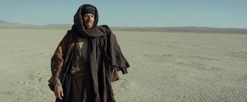 Movie still from “Last Days in the Desert” (2015), directed by Rodrigo García – A man standing in the middle of the desert; Medium shot, Over the shoulder angle