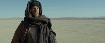 Movie still from “Last Days in the Desert” (2015), directed by Rodrigo García – A man standing in the middle of the desert; Medium shot, Over the shoulder angle