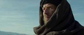 Movie still from “Last Days in the Desert” (2015), directed by Rodrigo García – A person wearing a turban and a blanket; Close Up shot, Low angle