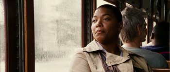 Movie still from “Last Holiday” (2006), directed by Wayne Wang – A woman sitting in front of an open window; Close Up shot, Low angle