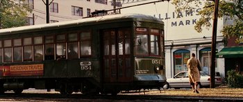 Movie still from “Last Holiday” (2006), directed by Wayne Wang – An old trolley car on the tracks near a building; Wide shot, Low angle