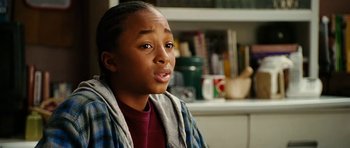 Movie still from “Last Holiday” (2006), directed by Wayne Wang – A young man sitting in front of a kitchen counter; Close Up shot, Over the shoulder angle