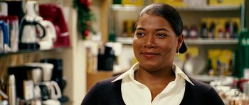 Movie still from “Last Holiday” (2006), directed by Wayne Wang – A person smiling for a picture; Close Up shot, Over the shoulder angle