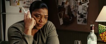 Movie still from “Last Holiday” (2006), directed by Wayne Wang – A woman sitting at a table talking on a phone; Close Up shot, High angle