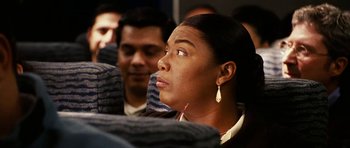 Movie still from “Last Holiday” (2006), directed by Wayne Wang – A woman sitting on a bus looking up at the sky; Close Up shot, Over the shoulder angle
