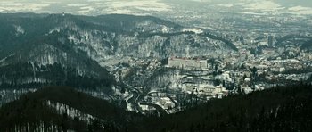 Movie still from “Last Holiday” (2006), directed by Wayne Wang – A view of a city from a mountain top in the snow; Extreme Wide shot, High angle