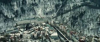 Movie still from “Last Holiday” (2006), directed by Wayne Wang – An aerial view of a city in the snow; Extreme Wide shot, High angle