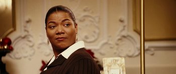 Movie still from “Last Holiday” (2006), directed by Wayne Wang – A person wearing a sweater; Close Up shot, Over the shoulder angle