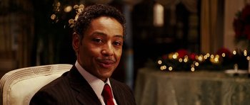 Movie still from “Last Holiday” (2006), directed by Wayne Wang – A person wearing a suit and tie; Close Up shot, Over the shoulder angle