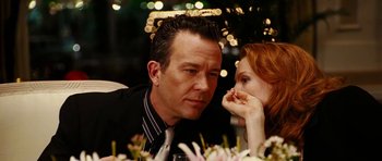Movie still from “Last Holiday” (2006), directed by Wayne Wang – A man and a woman sitting next to each other at a dinner table; Close Up shot, Over the shoulder angle