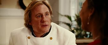 Movie still from “Last Holiday” (2006), directed by Wayne Wang – A person wearing a chef's outfit; Close Up shot, Over the shoulder angle