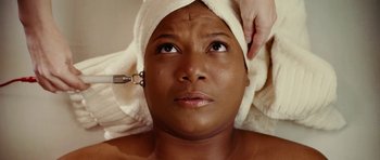 Movie still from “Last Holiday” (2006), directed by Wayne Wang – A woman is getting her face waxed at the spa; Close Up shot, Overhead angle