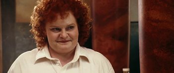 Movie still from “Last Holiday” (2006), directed by Wayne Wang – A person with curly red hair; Close Up shot, Low angle