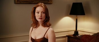 Movie still from “Last Holiday” (2006), directed by Wayne Wang – A woman with red hair wearing a brown dress; Close Up shot, Over the shoulder angle