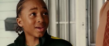 Movie still from “Last Holiday” (2006), directed by Wayne Wang – A person wearing a green and yellow jacket; Close Up shot, Over the shoulder angle
