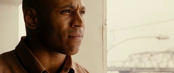 Movie still from “Last Holiday” (2006), directed by Wayne Wang – A man's face looking to his left; Close Up shot, Low angle