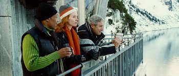 Movie still from “Last Holiday” (2006), directed by Wayne Wang – A group of people standing next to each other on top of a ski slope; Medium shot, Low angle